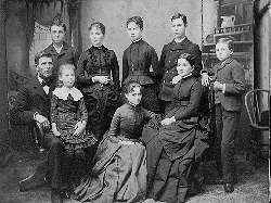O.S. Powell Family of River Falls, ca. 1886.  Standing:  Newell, Sarah, Lucy, Harvey, Lyman.  Seated:  Oliver S., Miriam, Amy and Lydia Elmira (Nichols) Powell